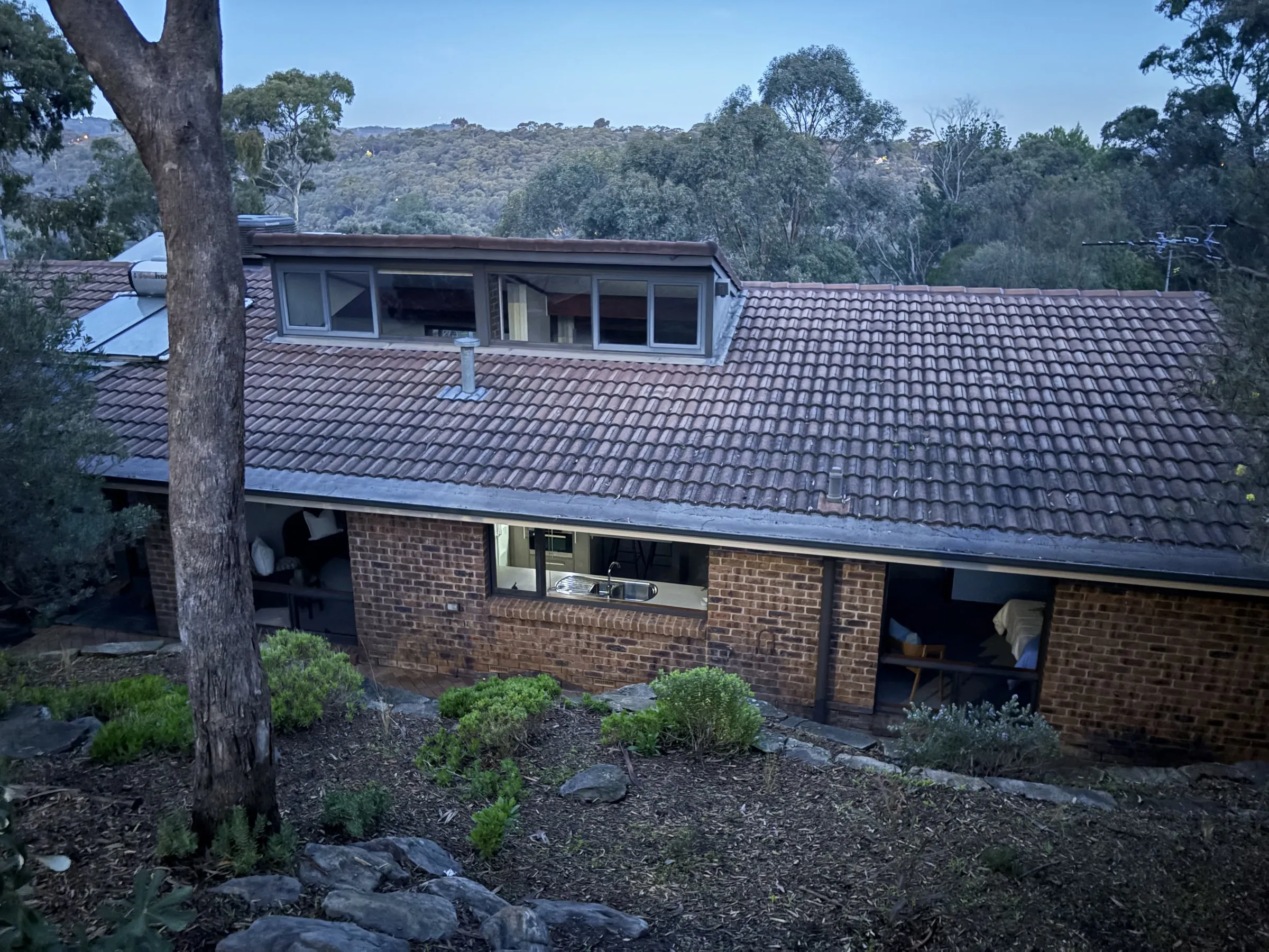 Brick home in the Adelaide foothills with clean windows at dusk