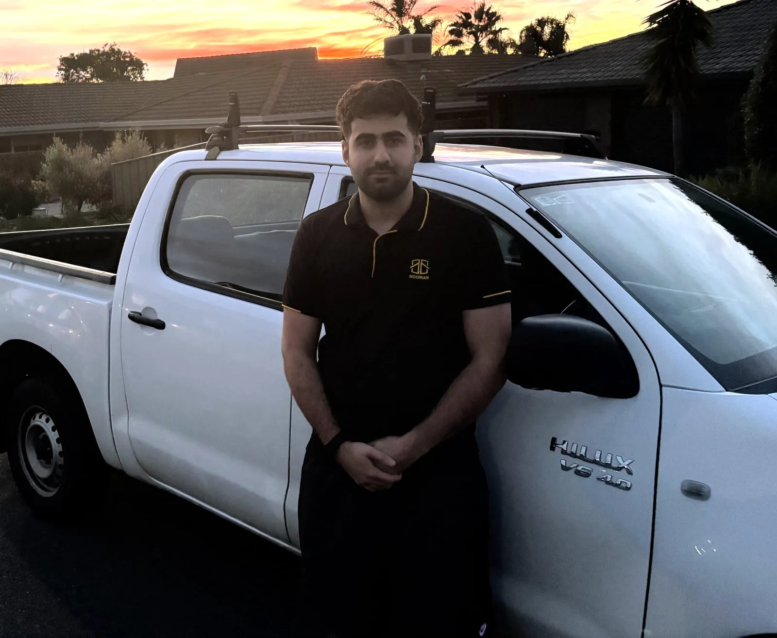 Ben, founder of Noorian Window Cleaning, with his work ute at sunset
